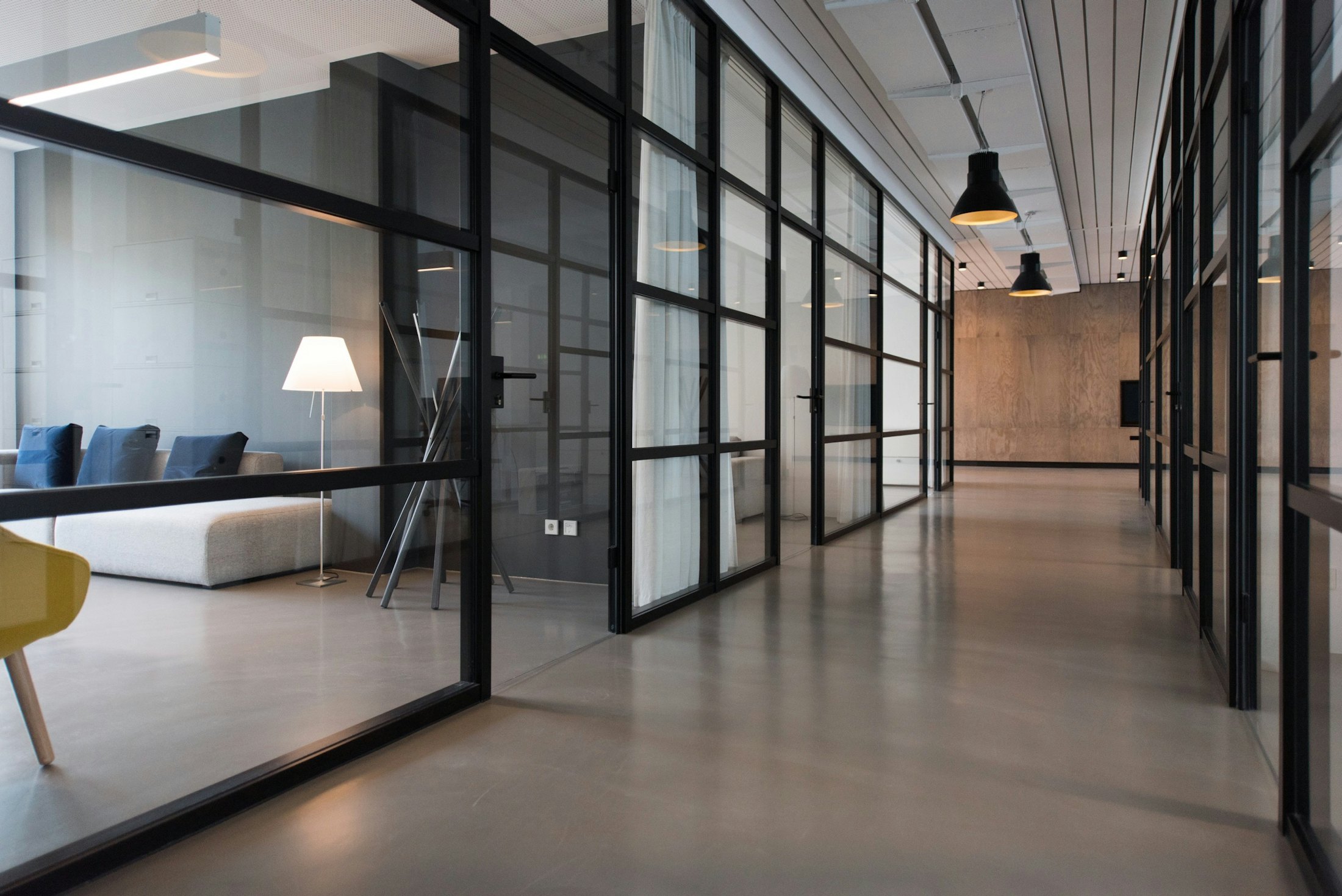 A lit office corridor with an exit route