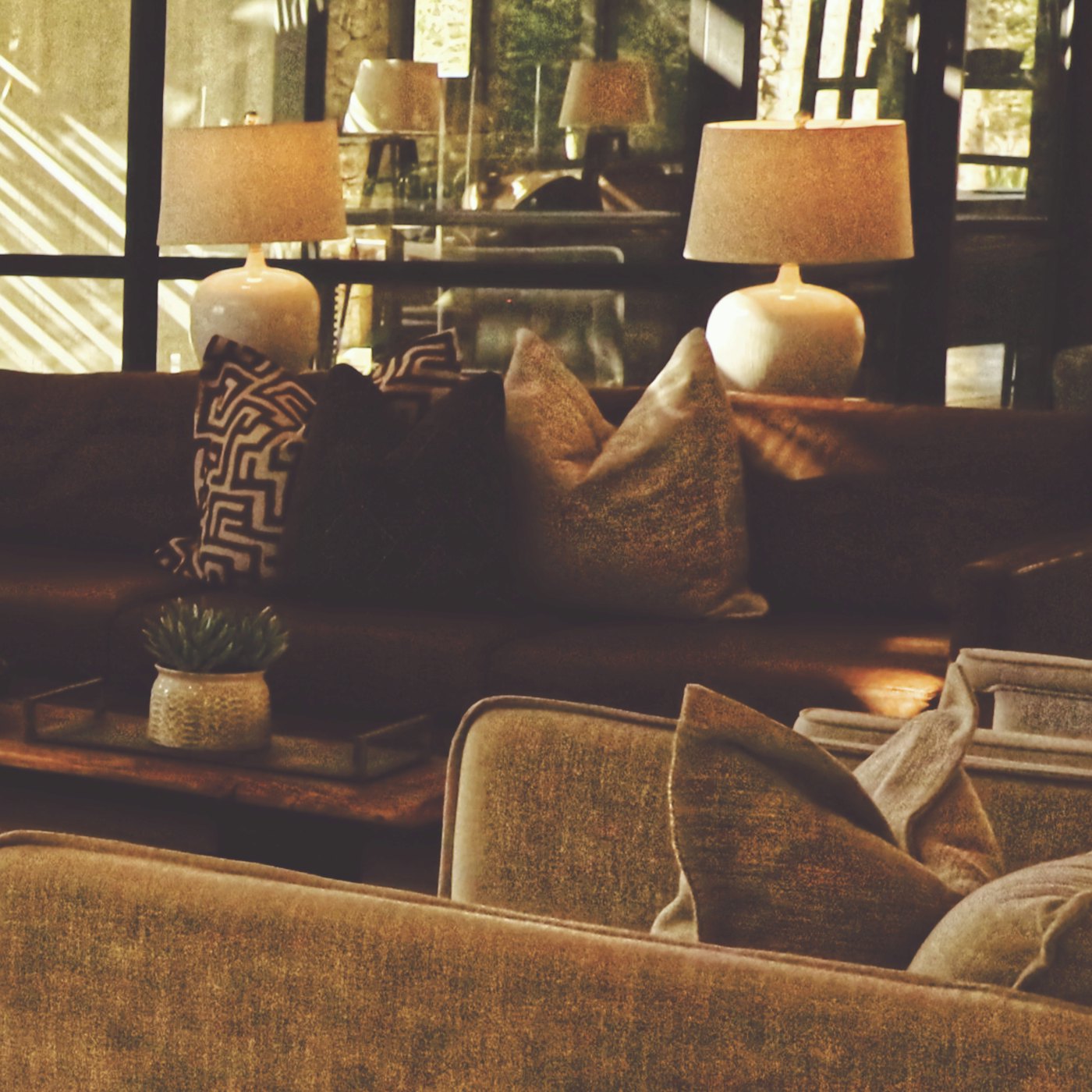 A cosy living room lit by warm lamps