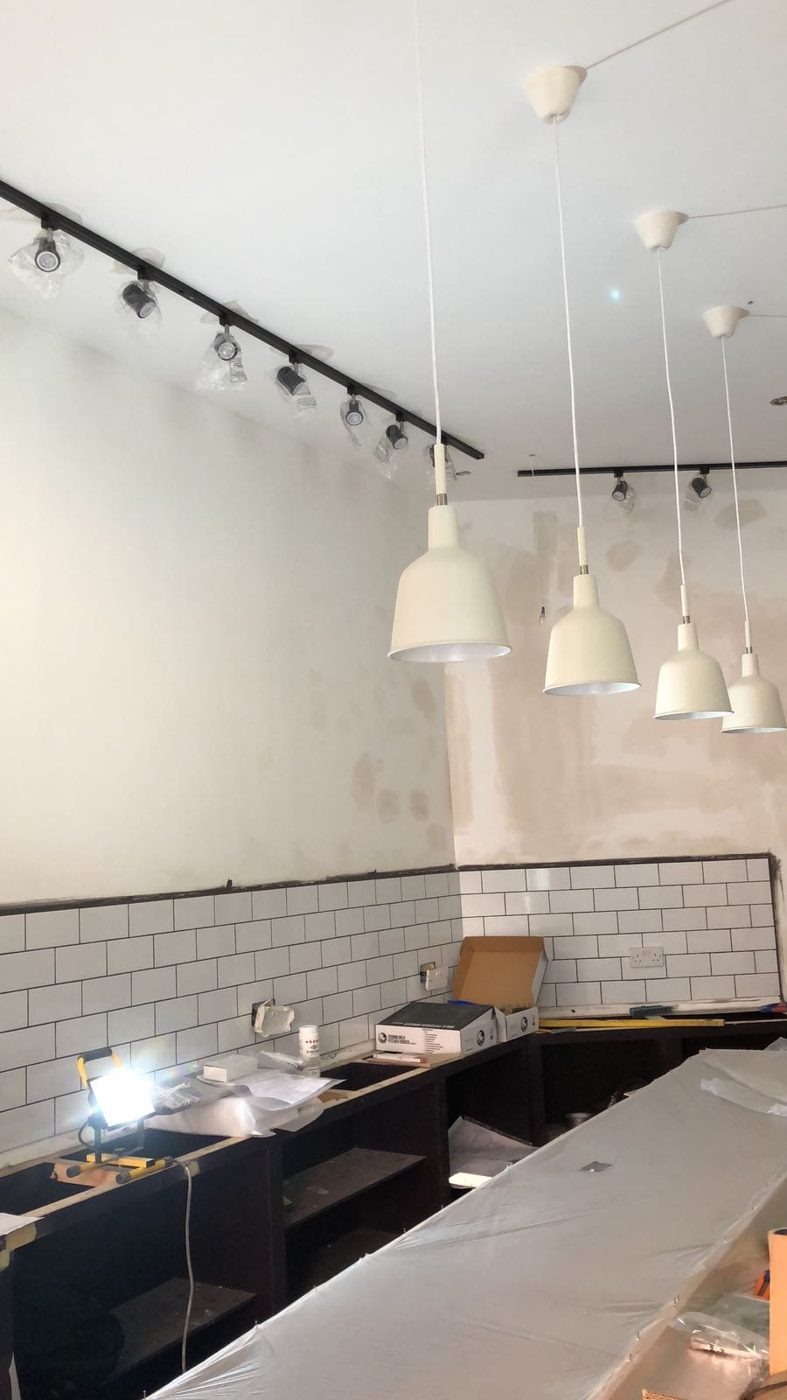 Counter pendants and sockets set into the tiled splashback