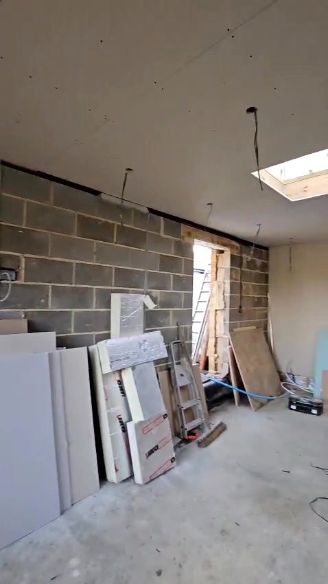 Before: bare blockwork, with first fix cables dropped in ready for the plasterers
