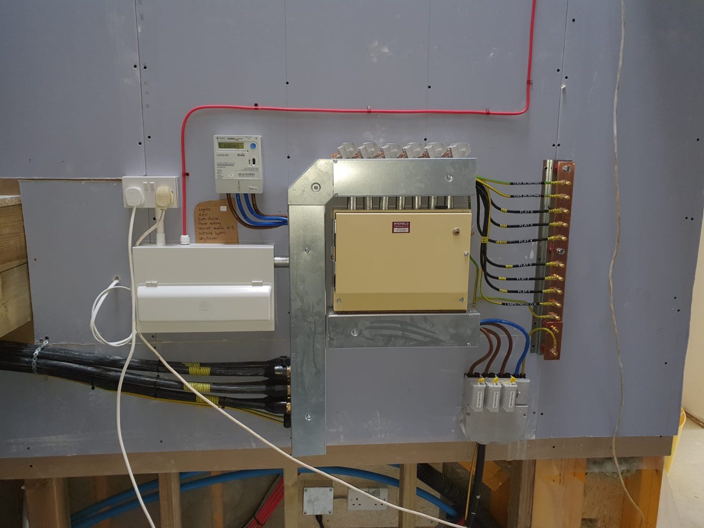 A landlord intake for a block of flats, with a labelled earth bar and a feed to each flat