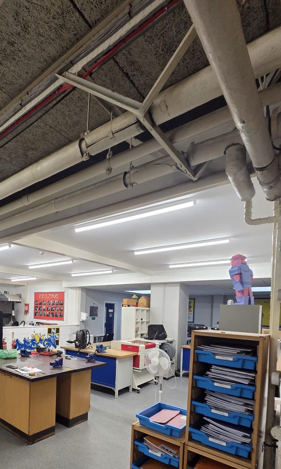 LED lighting in the open-plan making area, laid out around the services already on the ceiling