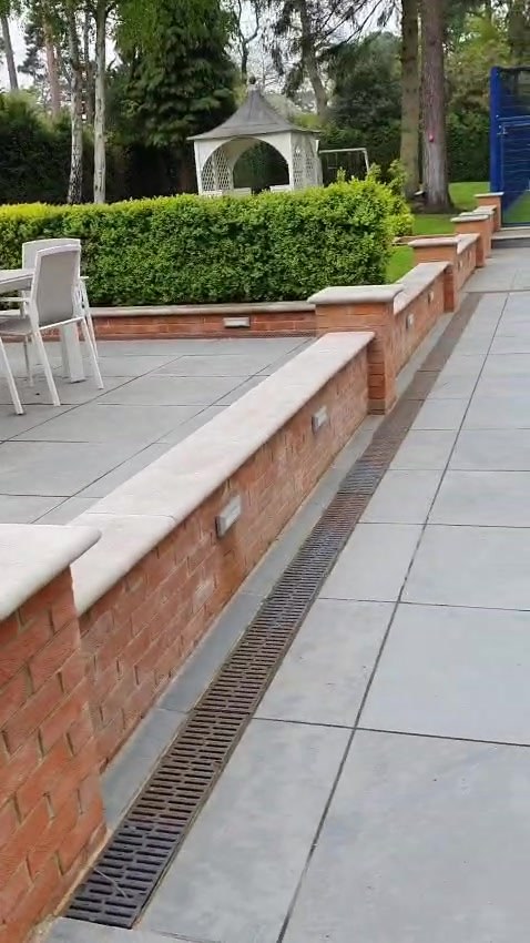 Brick lights set into the retaining walls, lighting the terrace steps and paths at night
