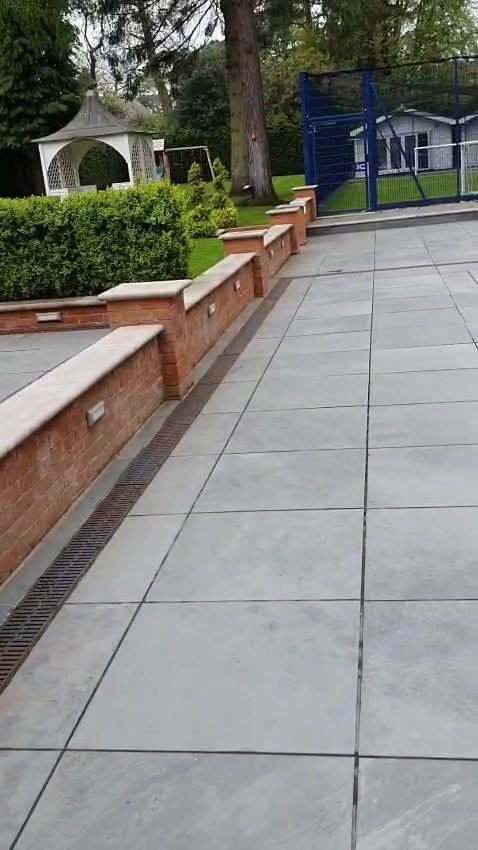 A long run of wall lights following the terrace down to the garden