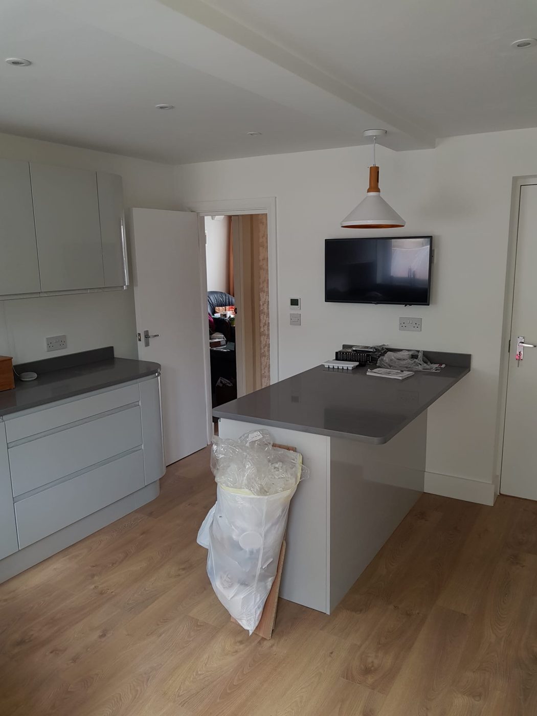 Kitchen extension with downlights, a pendant over the island, a TV point and heating controls