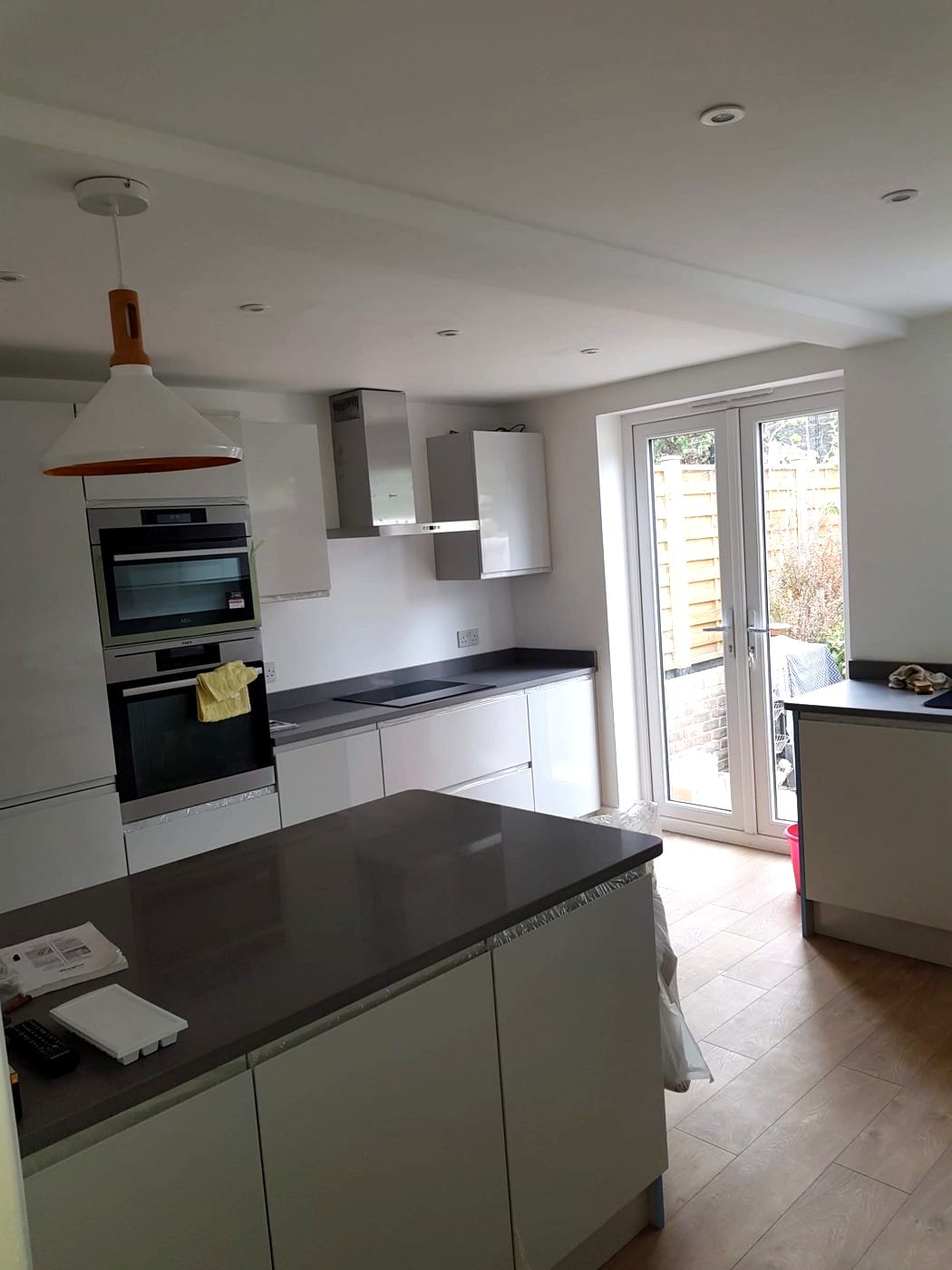 Downlights, an island pendant and dedicated supplies for the oven stack and induction hob