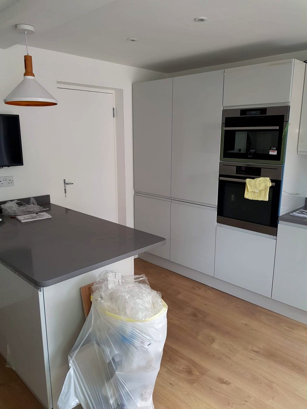 Sockets and a wall-mounted TV point, with the tall oven and fridge housing wired in