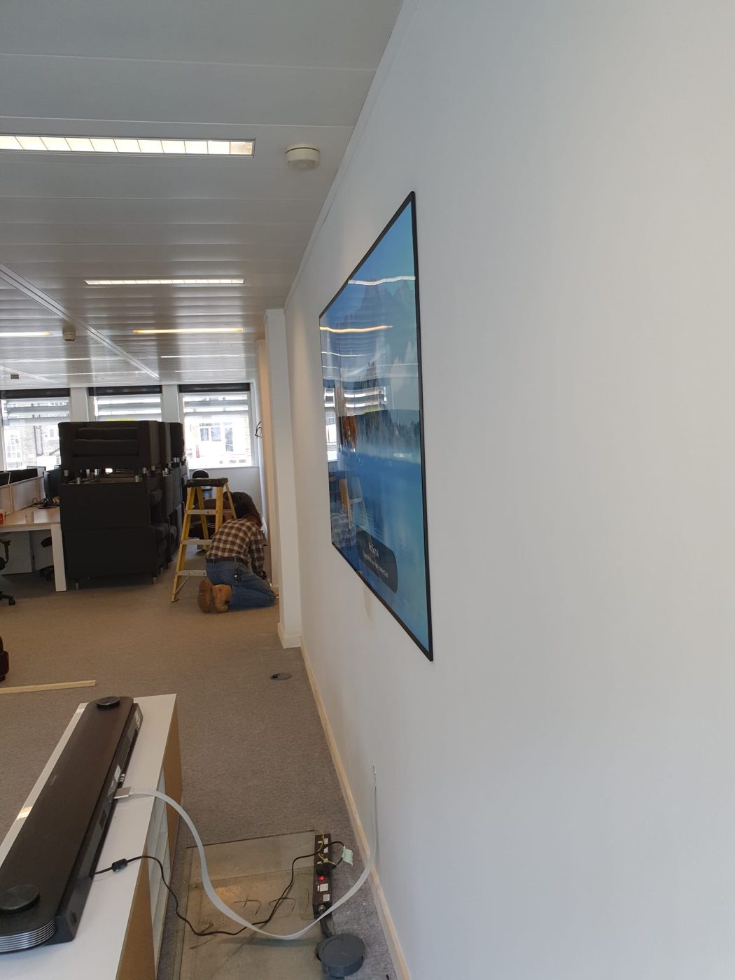 Power and data run from a floor box under the raised access floor, so no cables trail across the office