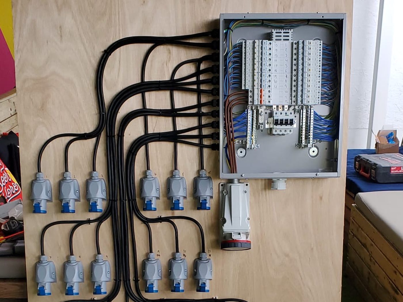 A temporary power distribution board with rows of 16A outlets
