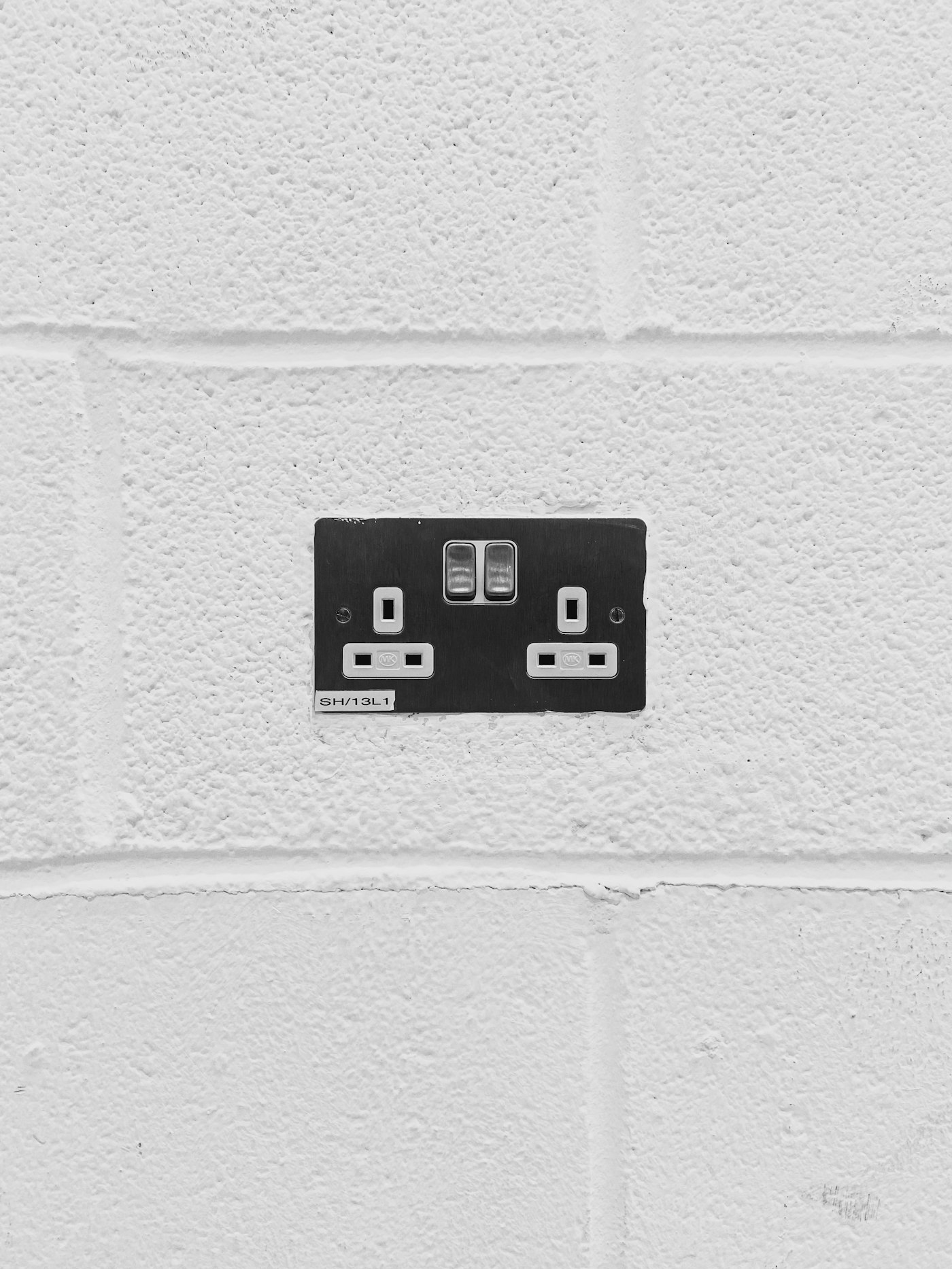 A modern double socket on a white wall